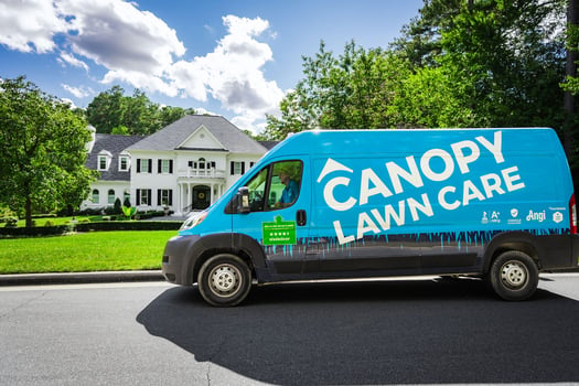 Canopy Lawn Care Truck parked in front of suburban home